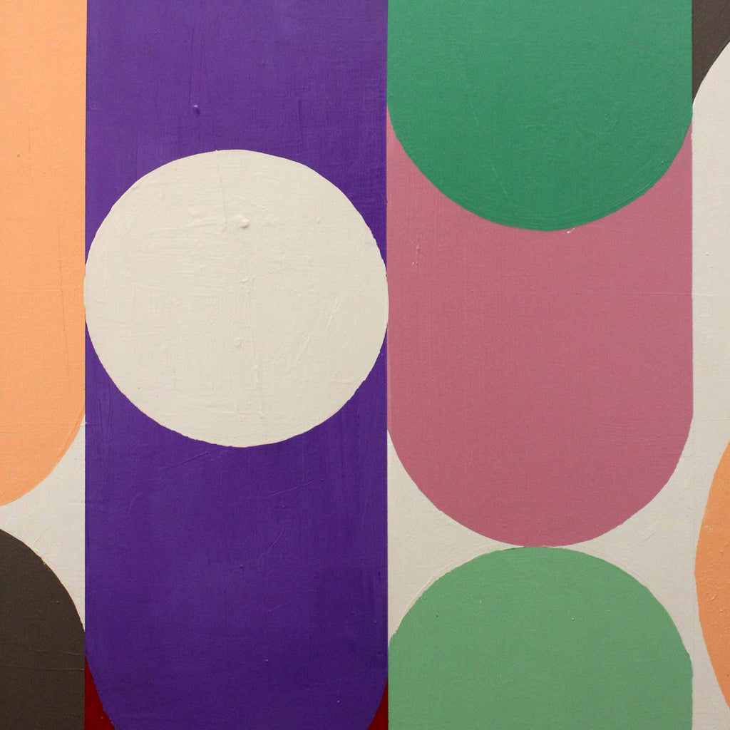 Close up detail of abstract geometric wall art featuring bold painted shapes including a large white oval on a purple vertical panel, a pink arch on a white background, green arches, and peach sections.