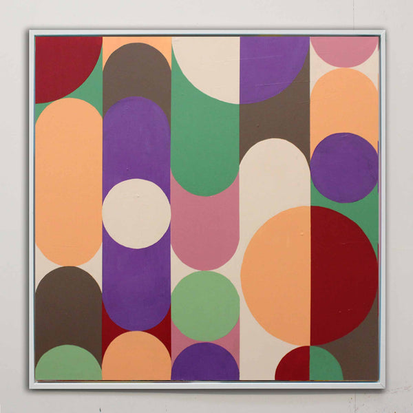 A square framed abstract geometric painting by Andy Watt at AW Modern Art featuring overlapping vertical and curved shapes in purple, green, orange, red, pink, brown, and cream on a light gray wall.