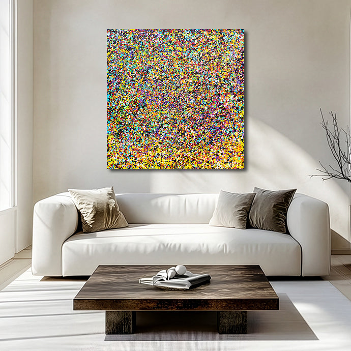 Rainbow Showers - A square abstract canvas painting with a dense multi-colour confetti pattern hangs on a beige wall above a modern white sofa in a bright, sunlit living room.