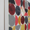 Side view of framed abstract geometric wall art featuring a grid of painted circles and half-circles in red, black, grey, Ocher, and white, shown hanging against a white studio wall.