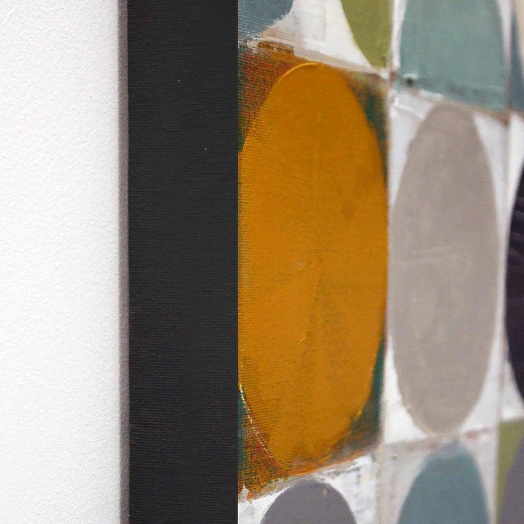 Close-up of an abstract canvas painting featuring a bold mustard yellow oval, a large gray oval, teal and white blocks, and a thick black vertical stripe against a white wall.