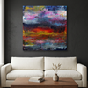 Flamingo Sunset - Abstract canvas wall art painting featuring a colourful sunset landscape with blue, purple, red, yellow, and black brushstrokes, displayed above a white sofa in a modern living room setting.