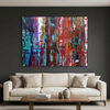 Fracture - A large abstract canvas painting with vibrant red, blue, purple, and white brushstrokes, displayed on a dark charcoal wall above a modern beige sofa with decorative pillows and a wooden coffee table.