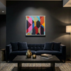 A colorful abstract geometric wall art painting with a white frame hangs above a dark navy velvet sofa in a modern living room setting with a wooden coffee table and a floor lamp.