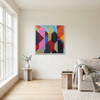 A white framed colourful abstract geometric wall art painting with bold hexagonal shapes hanging in a white minimal room with full height window to the left.