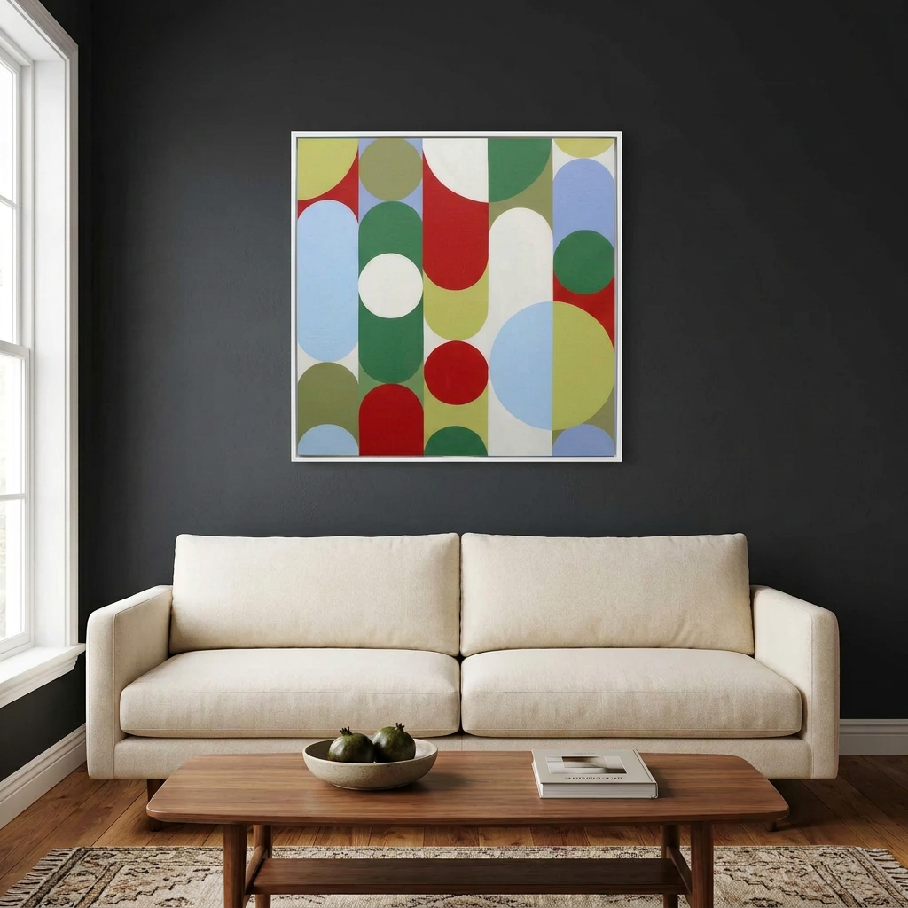 Geo Pop Lines No 2 - A square framed abstract wall art painting with overlapping circles and arcs in red, green, blue, yellow, and white, displayed above a cream sofa in a dark living room. A small dimension marker reads 22cm.