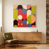 Geo Pop Lines No 6  A colourful abstract geometric wall art painting with overlapping vertical and circular shapes in red, orange, yellow, green, blue, pink, and cream, displayed above a mid-century modern wooden sideboard in a bright living room.