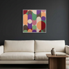 Geo Pop Lines No 9 - A square framed abstract wall art painting with overlapping colourful geometric shapes hangs above a cream sofa in a modern living room setting.