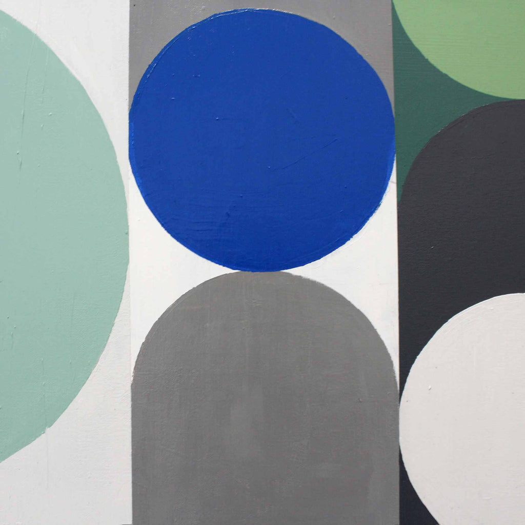 Abstract geometric wall art featuring bold painted circles and arches in blue, mint green, gray, black, and white.