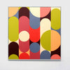 A square abstract geometric wall art painting featuring overlapping vertical bars and circles in muted red, blue, yellow-green, peach, cream, and dark brown tones, shown hanging on a white wall.