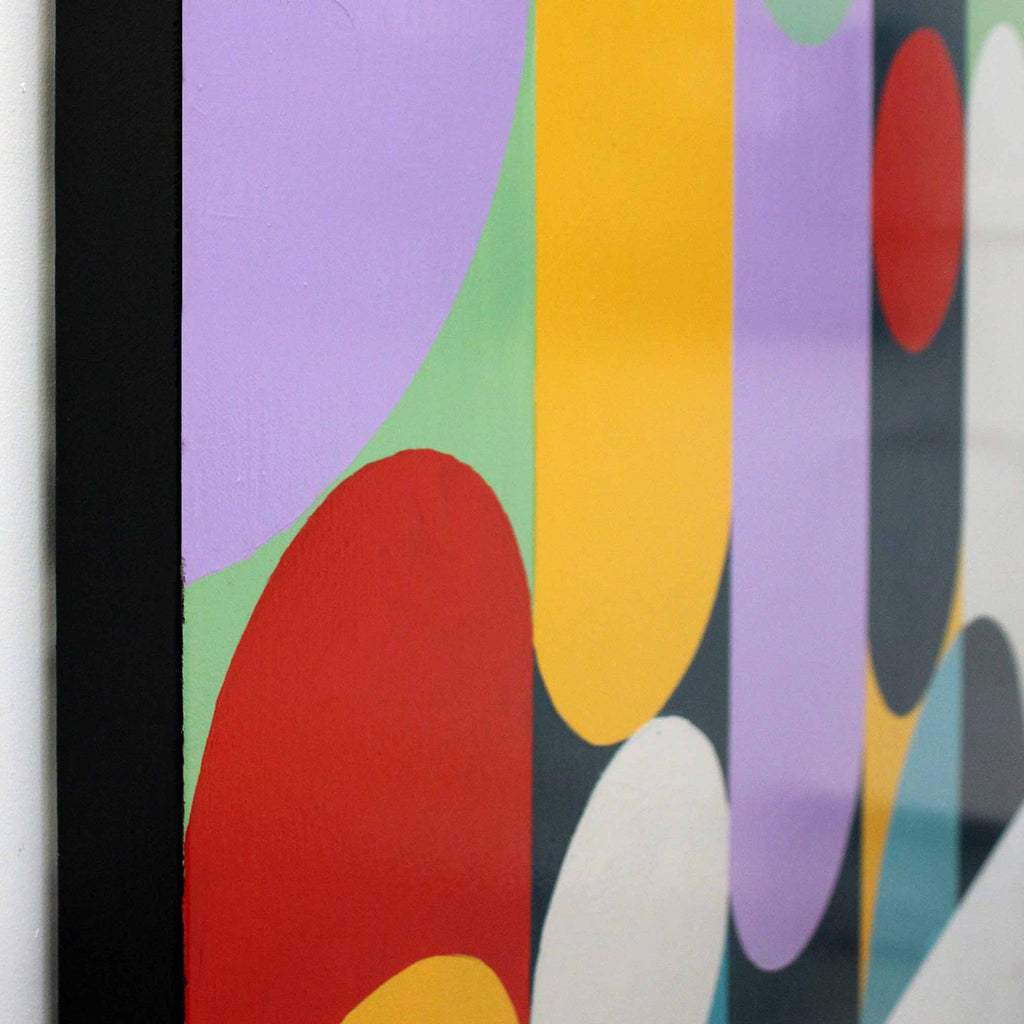 Close-up of a colorful abstract artwork with overlapping organic shapes in purple, green, yellow, red, white, and dark gray, bordered by a black frame.