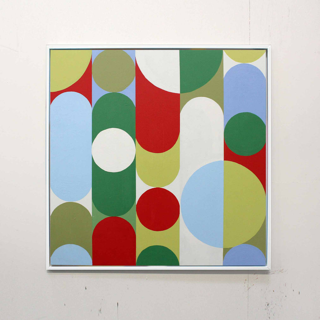 A square framed abstract art painting featuring a mid-century modern geometric pattern of overlapping arches, circles, and vertical bars in red, green, light blue, olive green, and white, hung on a textured off-white wall.