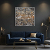A square framed abstract wall art painting with a textured marbled pattern in black, white, grey, and warm gold-brown tones, displayed above a dark blue velvet sofa in a modern living room setting.