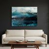 Nordic Mist - An abstract canvas wall art painting featuring shades of teal, blue, and black, displayed in a modern living room setting above a cream coloured sofa and a wooden coffee table.
