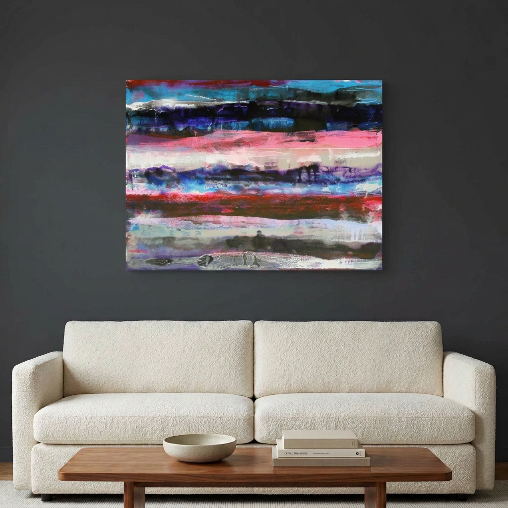 Pink Fathoms - An abstract canvas wall art painting with vibrant horizontal brushstrokes of pink, blue, purple, red, and black, displayed on a dark grey wall above a modern cream-coloured sofa with a wooden coffee table in front.