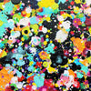 Rainbow Showers - A close-up of a colourful abstract paint splatter pattern on a black textured background, featuring splashes of yellow, blue, pink, orange, red, white, and purple.