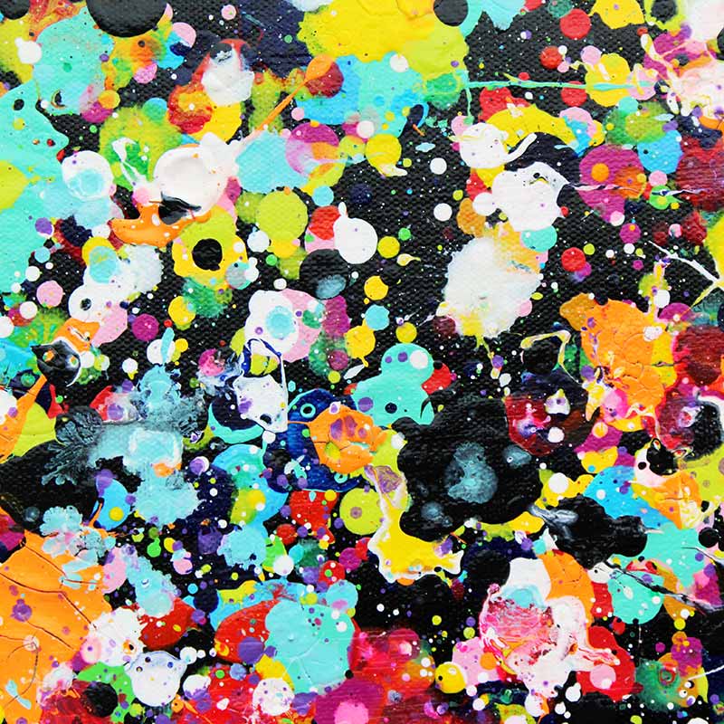 Rainbow Showers - A close-up of a colourful abstract paint splatter pattern on a black textured background, featuring splashes of yellow, blue, pink, orange, red, white, and purple.