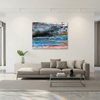 An abstract canvas wall art original painted artwork of a storm over the sea with blue, black, grey, white, and pink tones, displayed in a modern living room setting above a beige sectional sofa.