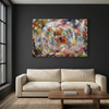 Turbulence - A large abstract canvas painting with a colourful swirling paint design is displayed on a dark charcoal wall above a modern beige sofa and a wooden coffee table.