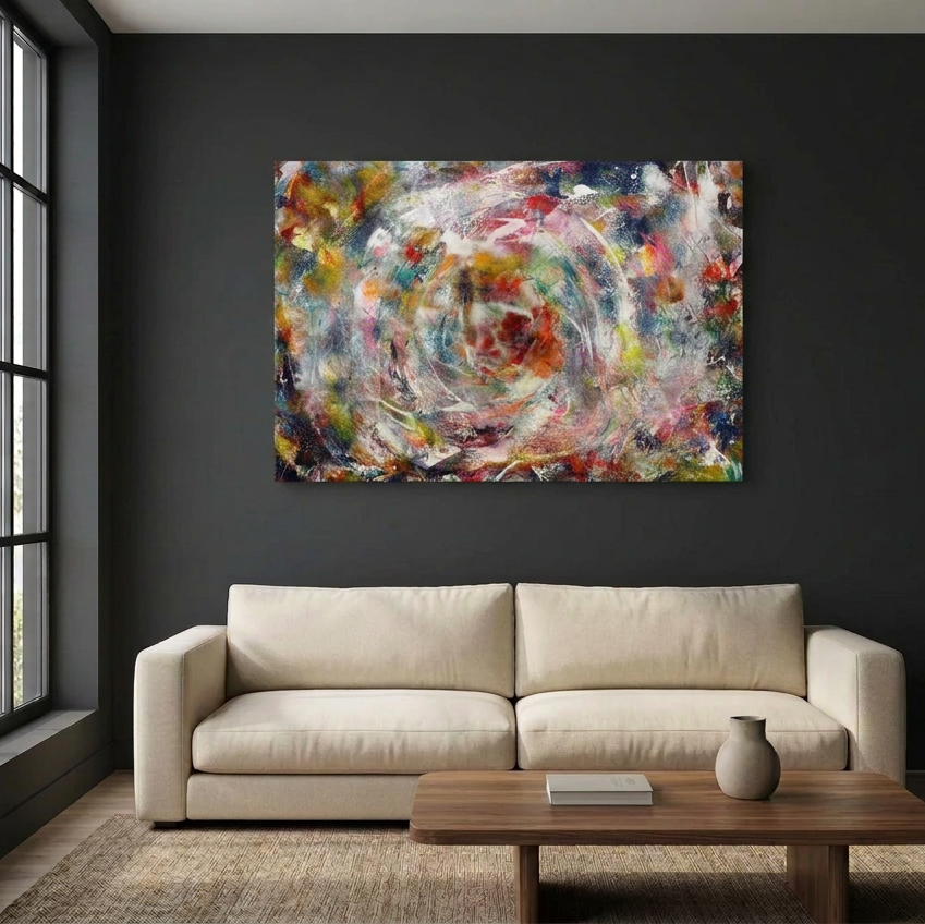 Turbulence - A large abstract canvas painting with a colourful swirling paint design is displayed on a dark charcoal wall above a modern beige sofa and a wooden coffee table.