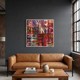 A large framed abstract canvas painting featuring layered graffiti-style 'NYC' lettering in red, blue, white, black, and orange, displayed on a dark grey wall above a tan leather sofa in a modern living room setting.