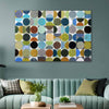 A large rectangular abstract wall art piece with a grid of multicolored circles hangs above a mint green sofa in a styled living room.