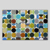 An abstract geometric canvas print featuring a grid of painted circles in various colors including blue, green, yellow, brown, black, and gray, displayed against a solid light gray background.