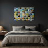 Vintage Spheres No 2 - A modern bedroom scene featuring a large canvas wall art painting with an abstract pattern of colourful circles, hung on a dark charcoal wall above a neatly made bed.