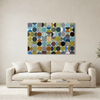 Vintage Spheres No 2 - A large rectangular wall art painting with a grid of colourful circles in blue, green, yellow, brown, black, and grey tones, displayed above a light beige sofa in a bright living room.