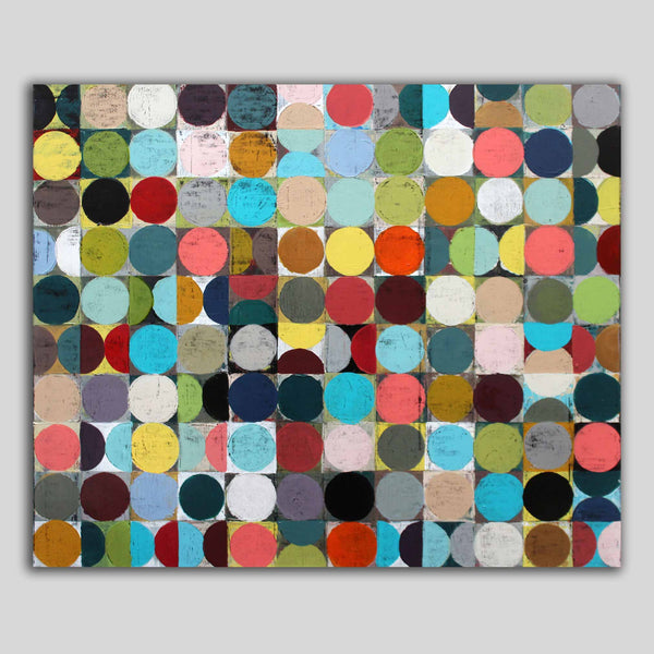 A multi coloured spot abstract canvas painting featuring a grid of vibrant painted circles in multiple colours, hanging against a light grey background.