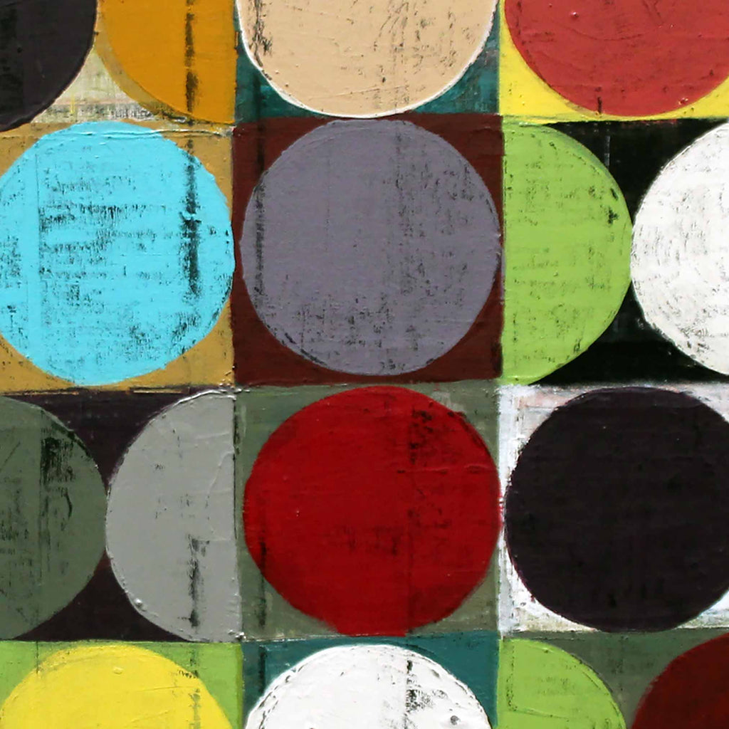 Close-up view of a colourful spot wall art painting of circles and half-circles in yellow, teal, red, grey, purple, green, and white on a grid background.