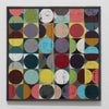 A square framed abstract artwork featuring a grid of colorful circles and half-circles in many muted and bright tones on a white wall.
