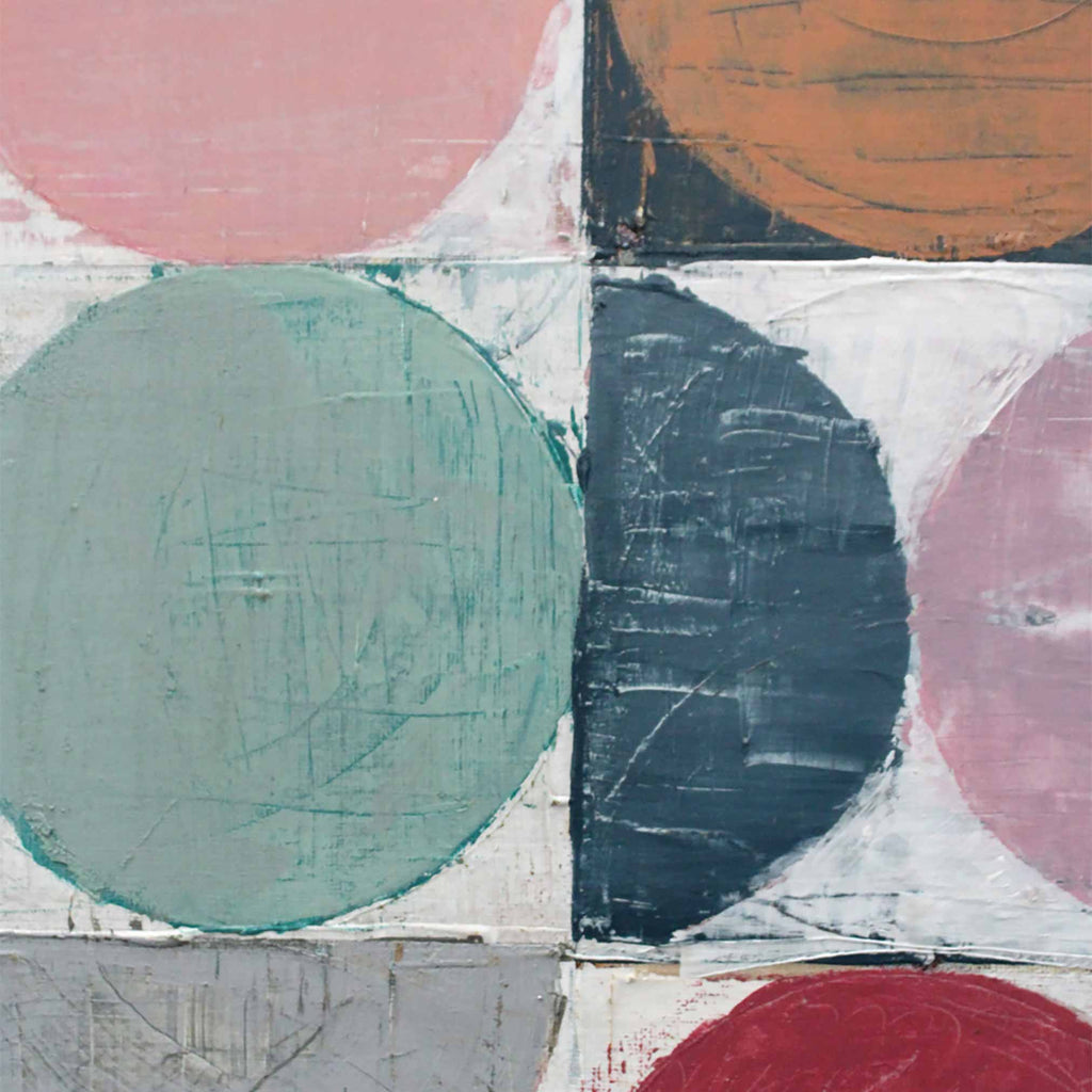 Abstract geometric wall art featuring textured painted circles in pink, teal, navy, rust, red, and gray on a white grid background.