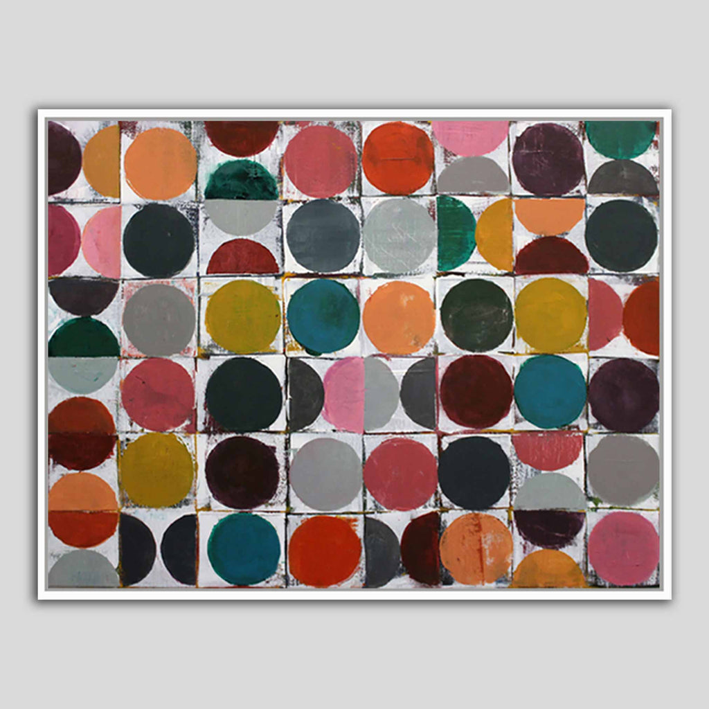 A framed abstract geometric wall art print featuring a grid of colored circles on a white background, shown against a neutral gray backdrop.