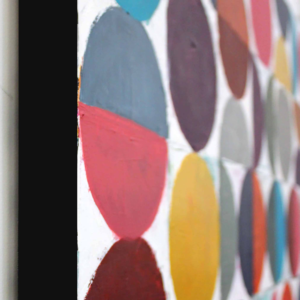 Close-up side view of a colourful abstract artwork featuring overlapping painted circles and semicircles in muted blue, red, purple, yellow, grey, and brown tones on a white background.